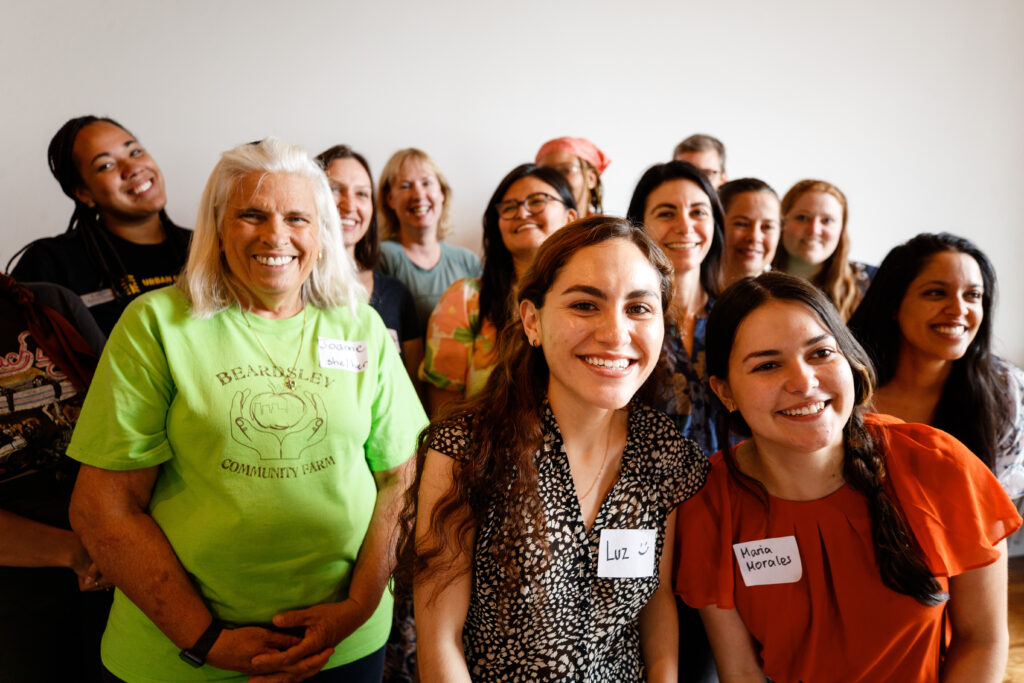 Group of people taking a group photo smiling at the camera