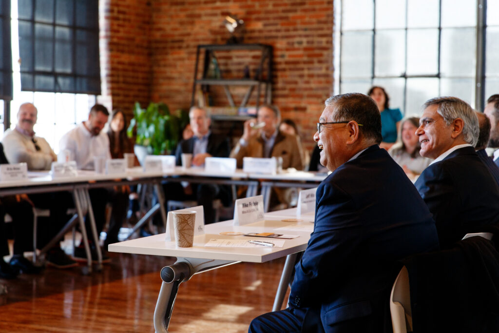 room of executives sitting around a brightly lit table