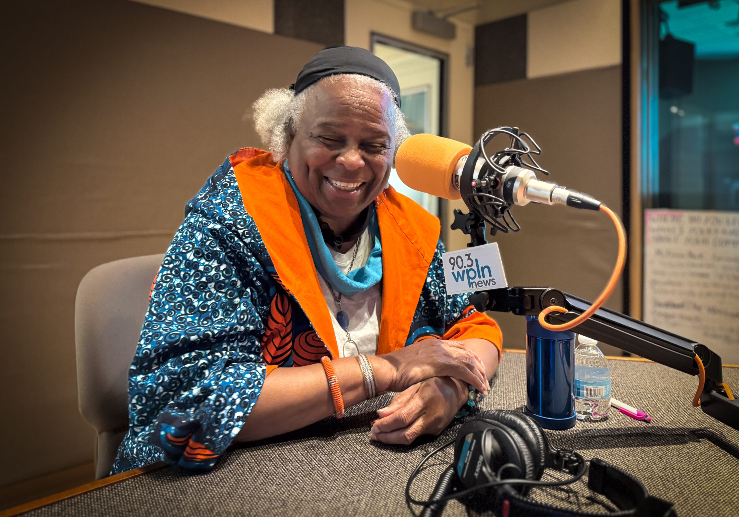 Freeman_Elois_2 Elois Freeman sitting at a microphone laughing