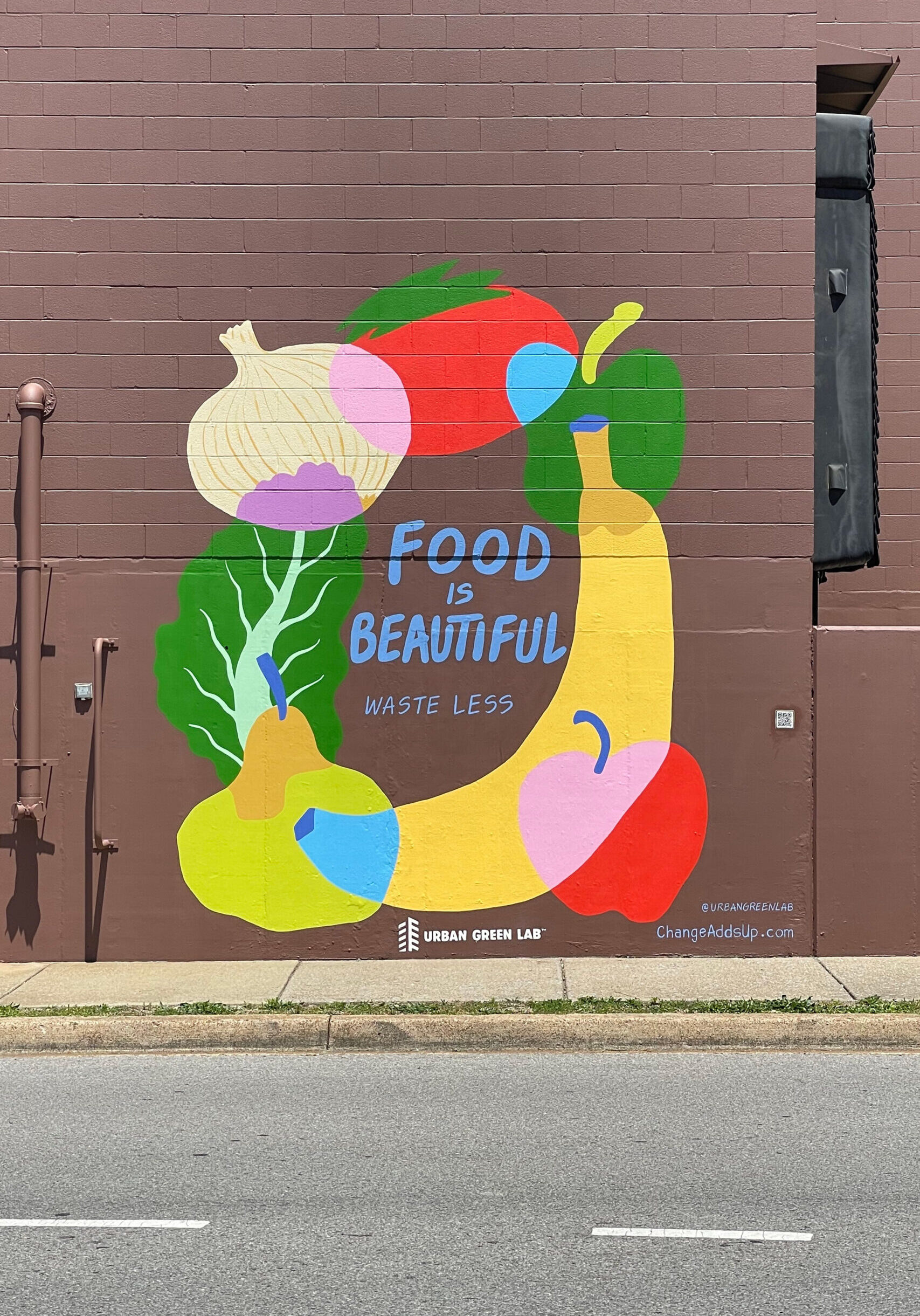 Mural that says "Food is Beautiful. Waste Less."