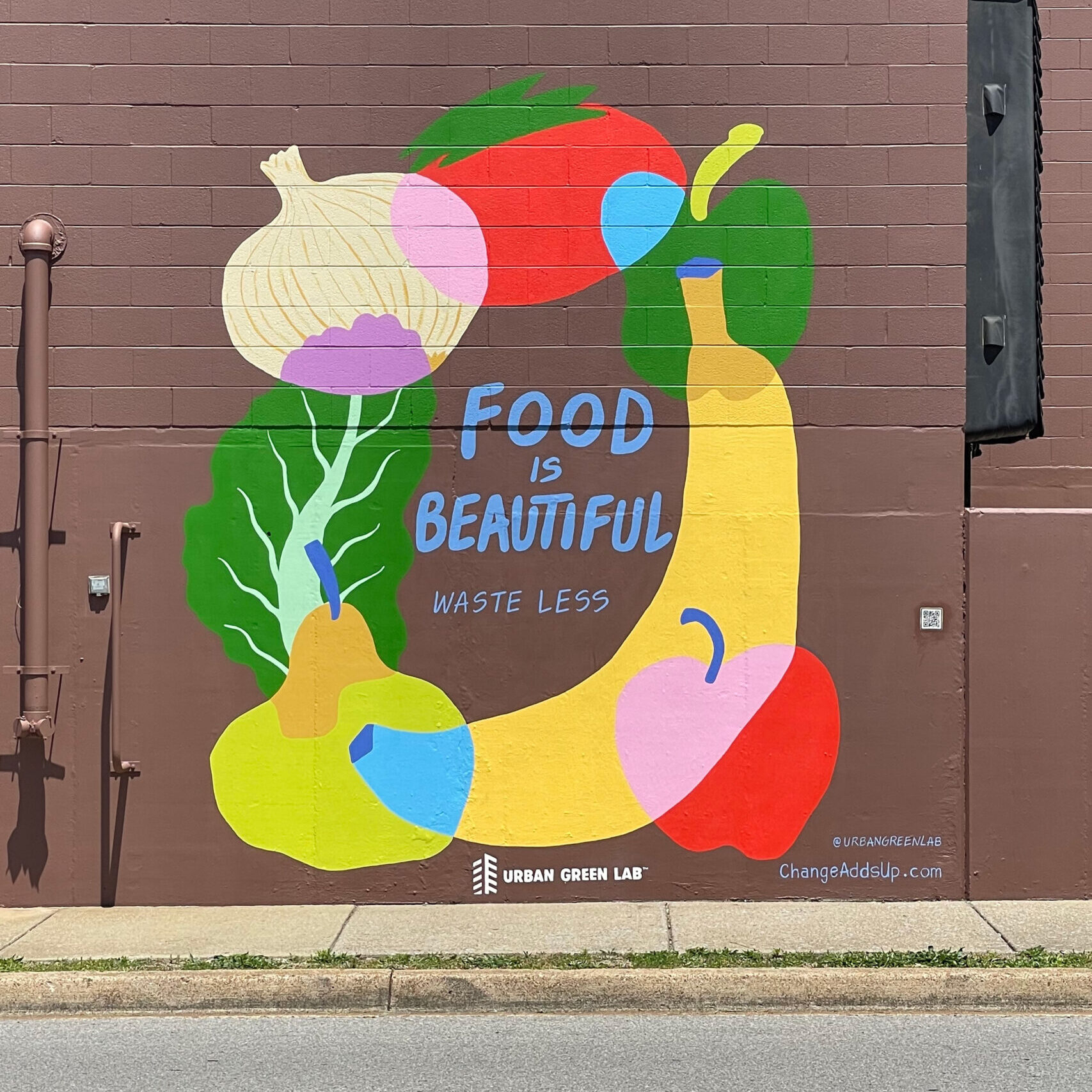 Mural that says "Food is Beautiful. Waste Less."