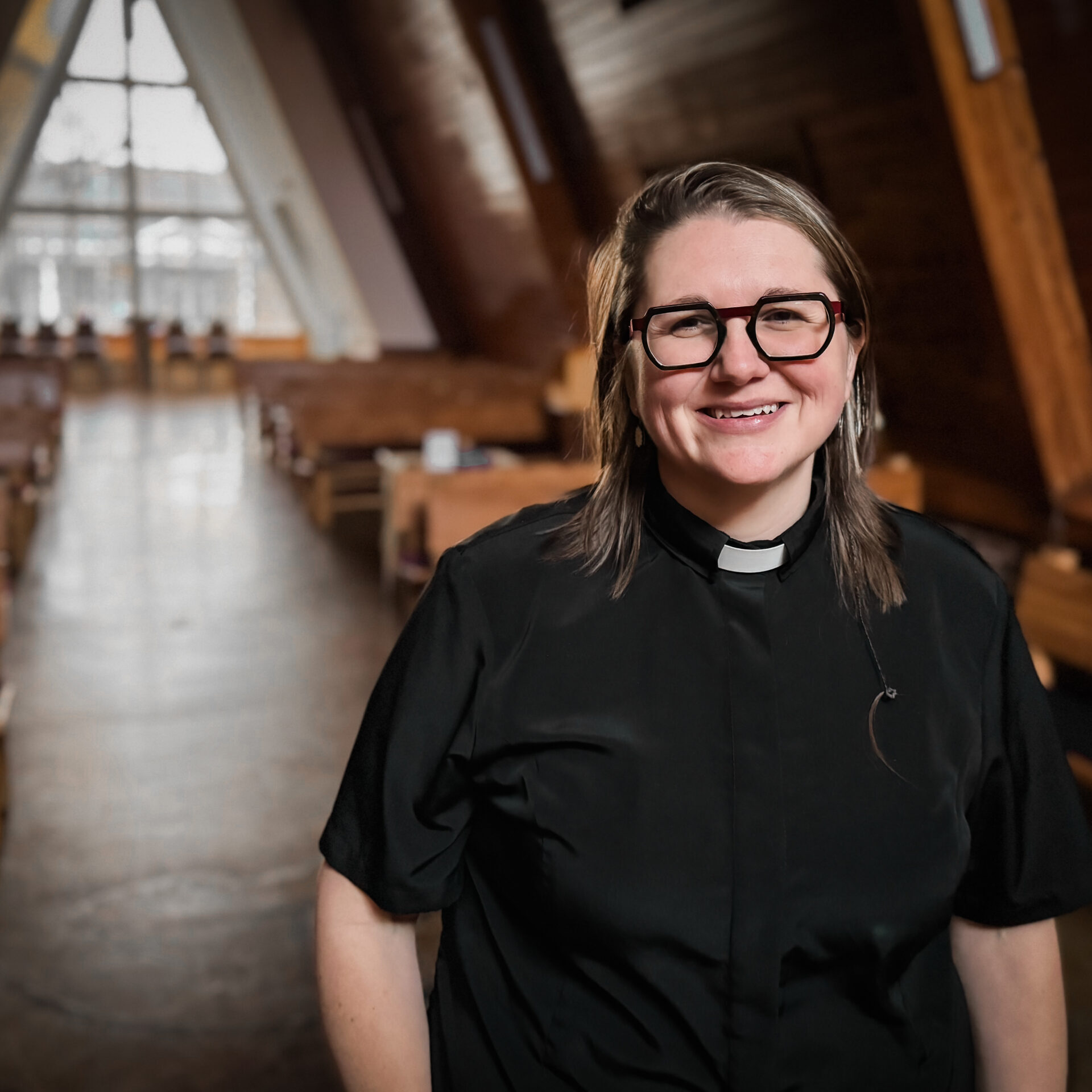 Reverend with indoor chapel behind her