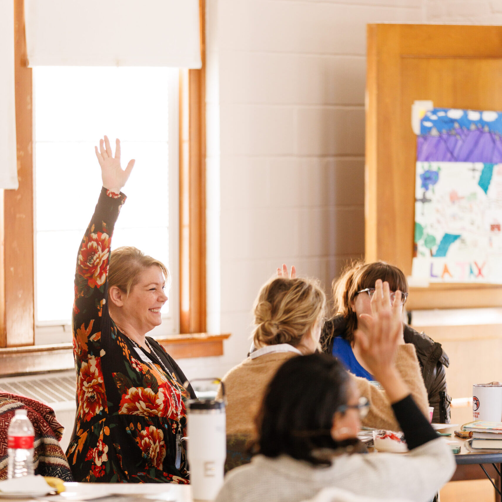 teachcer raises her hand in a sustainable classrooms trainings