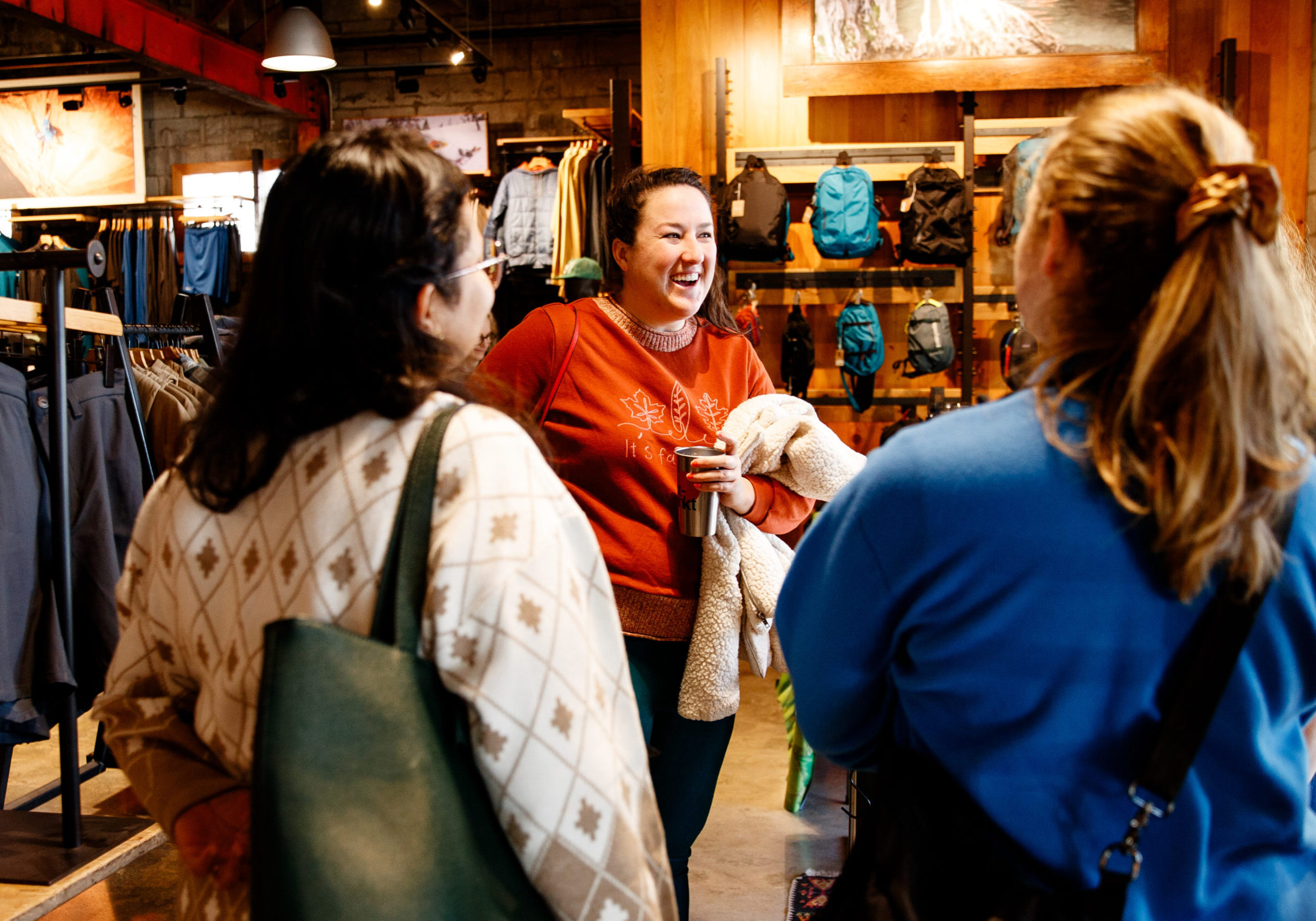 Women in red sweater talking and laughing with two other women