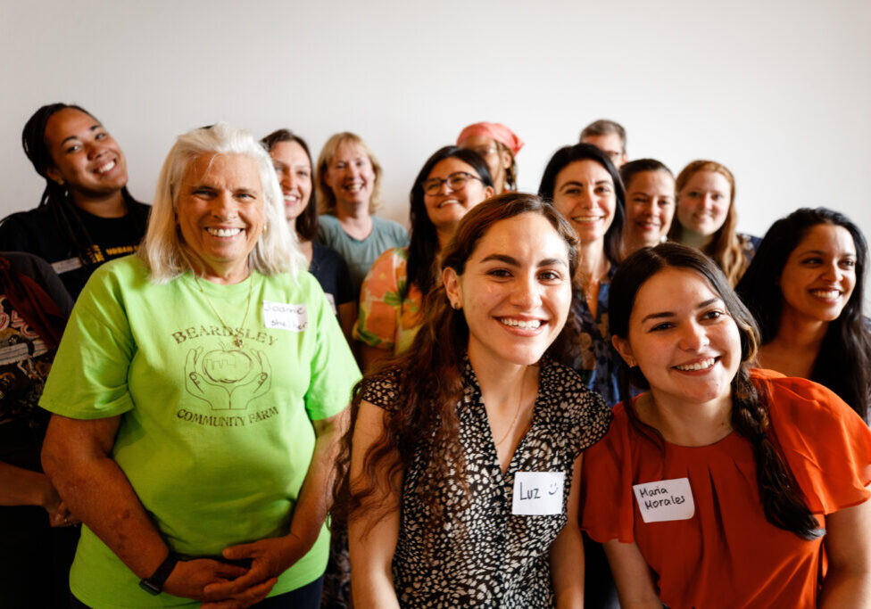 Group of people taking a group photo smiling at the camera